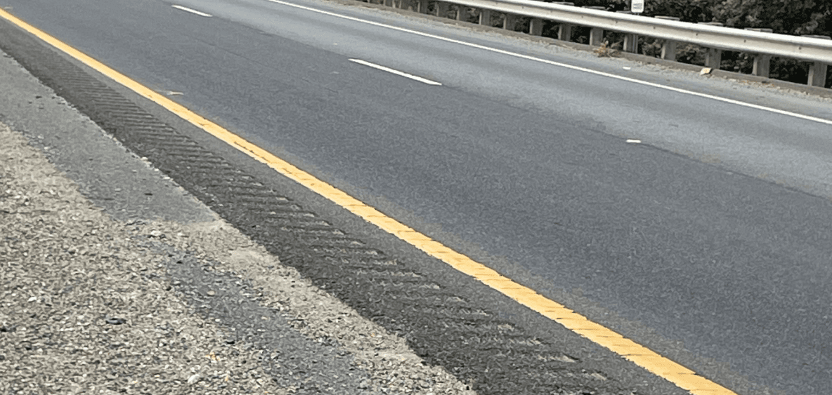 Split view of the same road surface, one side treated and one untreated